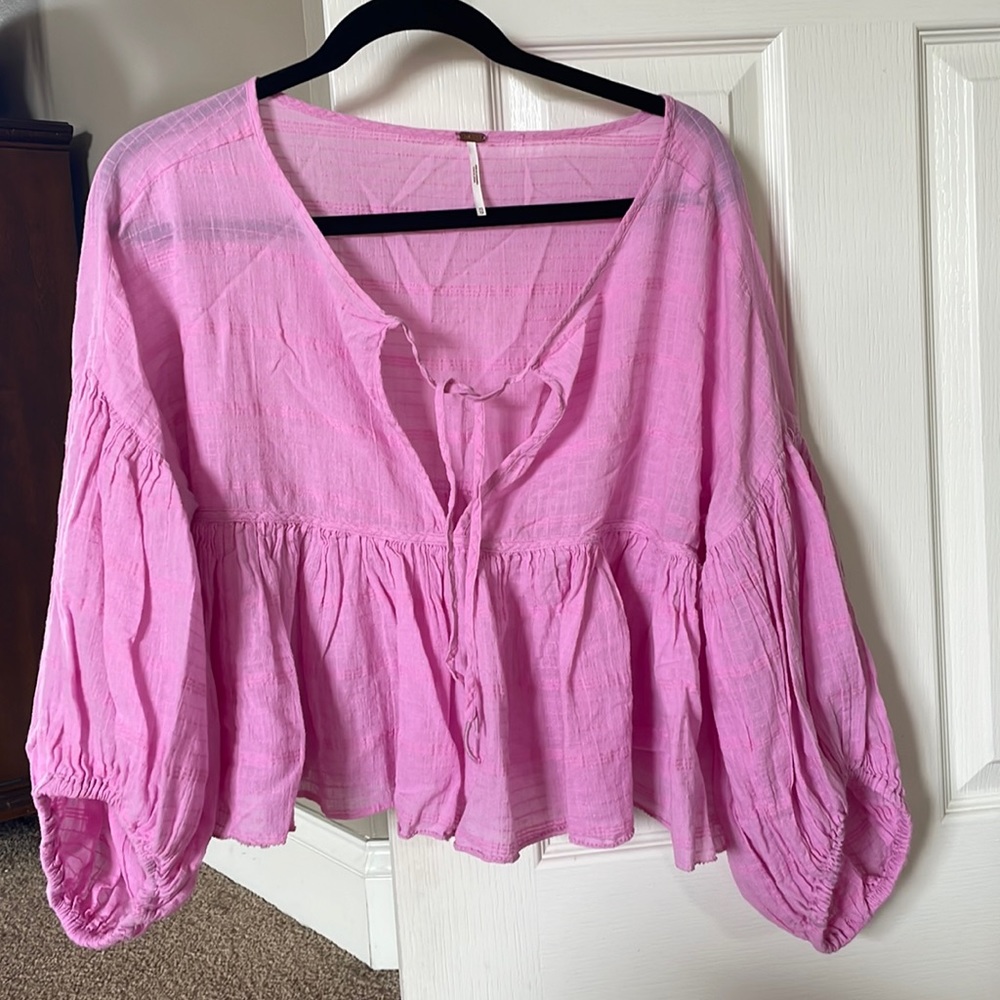 Free People blouse with ties in front. Wide puffy sleeves.